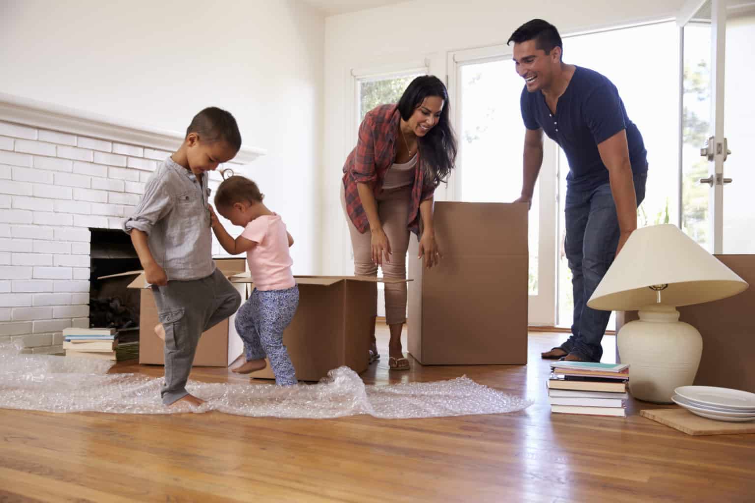 Family unpacking boxes in new home